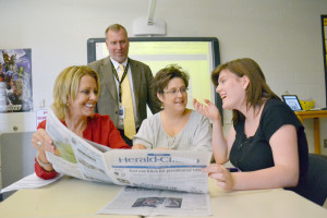 Joy McCaleb, left, mentor for Upperman High School's new student newspaper, left, shares her love of journalism with teacher Renee Craig, center, student Stephanie Maxwell and principal Billy Stepp.