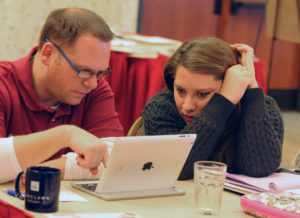 New advisers Erik Farrar (business teacher) and Elizabeth Miller (English teacher) work together as they learn how to start up a student newspaper during a media advising class at the summer workshop of the Kettle Moraine Press Association last summer. The Belleville (Wis.)High School staff and advisers are supported by JEA mentor, Dave Wallner. Photo by Linda Barrington.